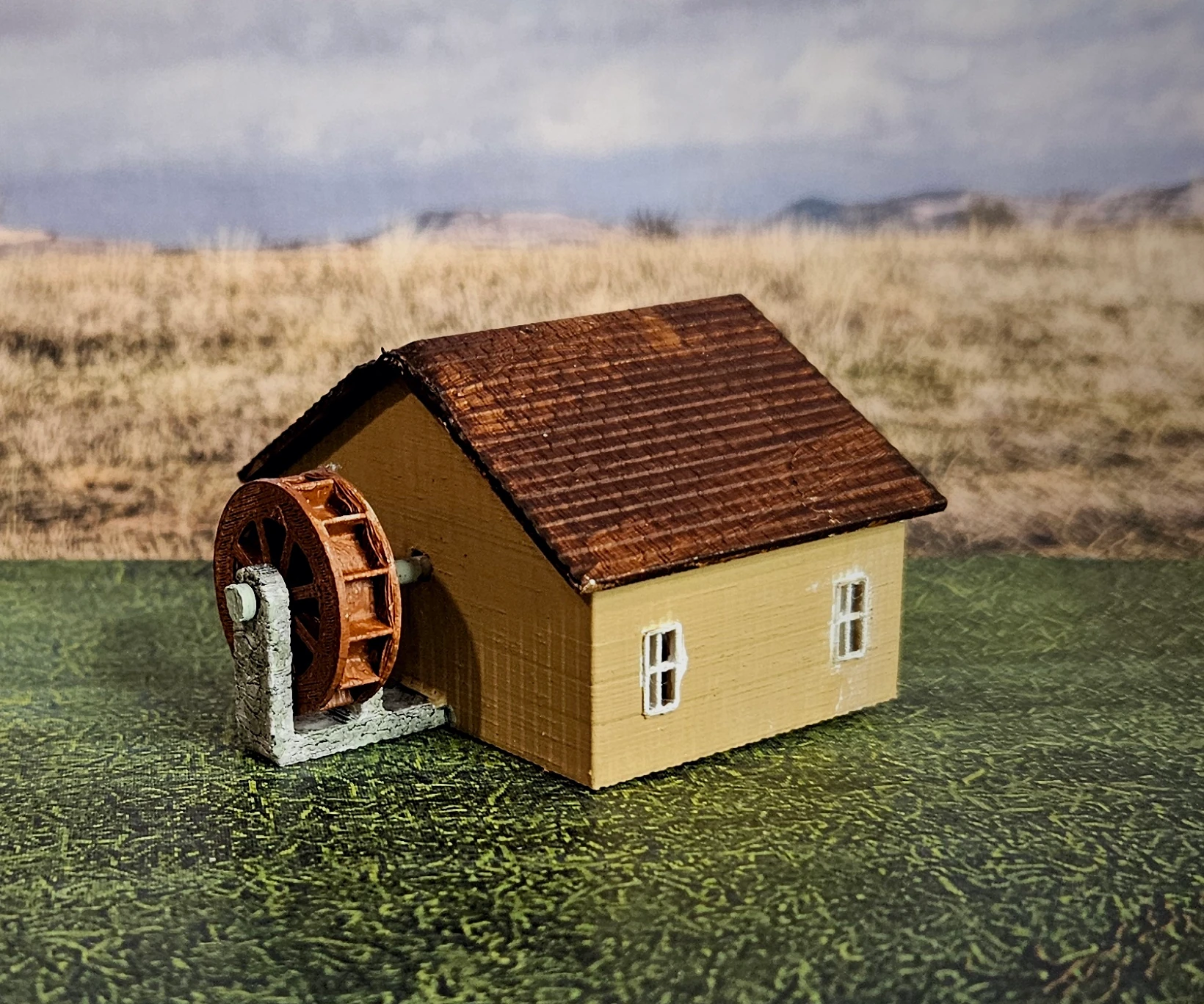 Side view of HO scale waterwheel with large building
